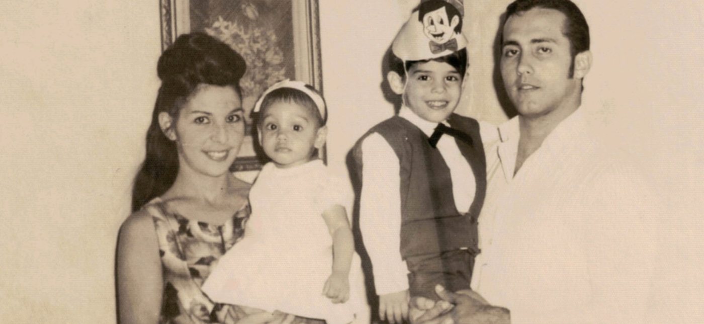 The same family photo before restoration, faded and sepia